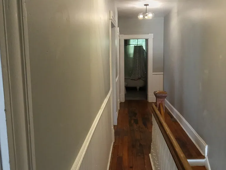 View of upstairs hall from other end looking into bathroom