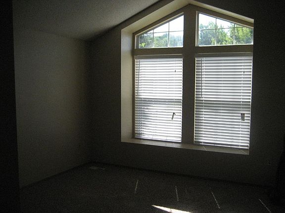 Open split level floorplan with large windwos and vaulted ce