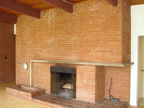 Expansive brick fireplace and hearth in greatroom