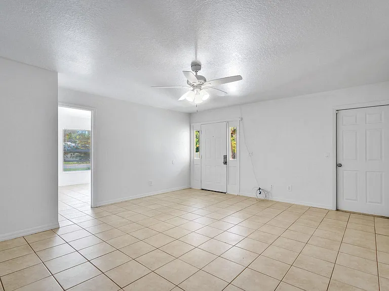 Living room. Door to the left is master bedroom, door in the middle is then entry door. Door to the right is to the garage.