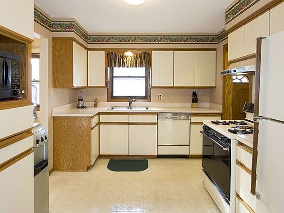 Fresh and clean kitchen with updated cabinet fronts and a tall pantry cupboard