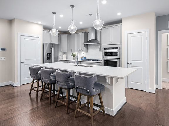 Gourmet Kitchen white Gray Cabinetry and Iced White Quartz