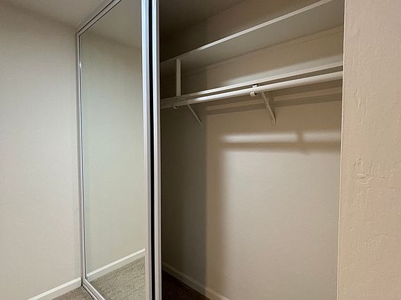 Spacious bedroom closet with 
Shelves on the top area