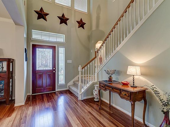 The entry welcomes you inside with a grand 2 story high ceiling.