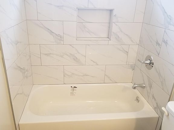 Brand new tub, new designer tile surround, new fixtures.