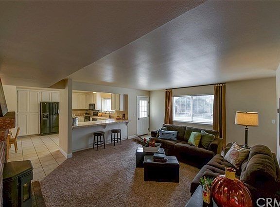 Family room with eating bar and fireplace.
