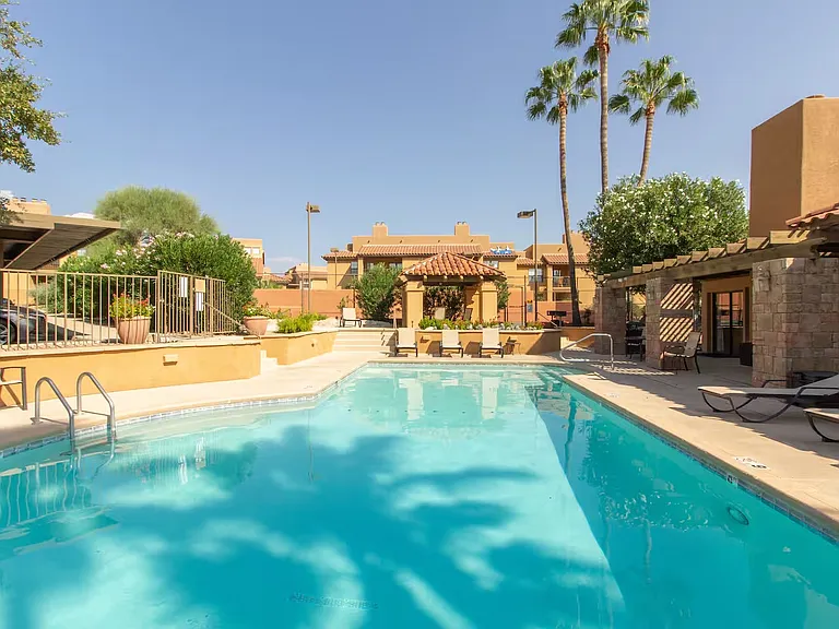 Community pool features ample seating, charcoal grills and a jacuzzi