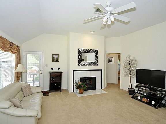 This view of the den showcases the gas log fireplace