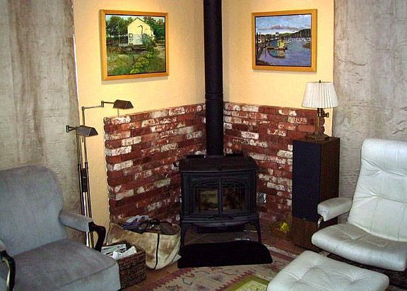 wood stove/fireplace in corner of livingh room