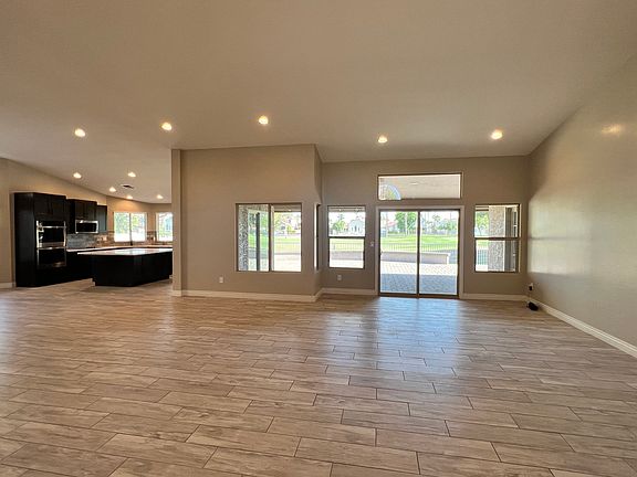 A great room greets you as you enter this home with a wall full of windows and a peaceful view of the golf course