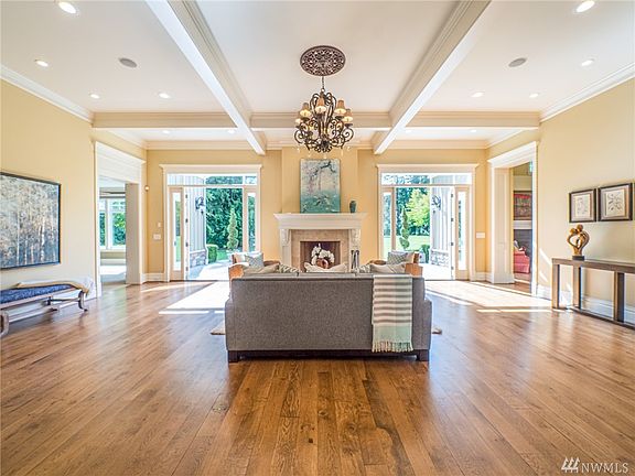 Step into the front door to be living the NW dream with Vintage White Oak wide plank hardwoods, Custom Restoration Hardware lighting and coffer beamed ceilings