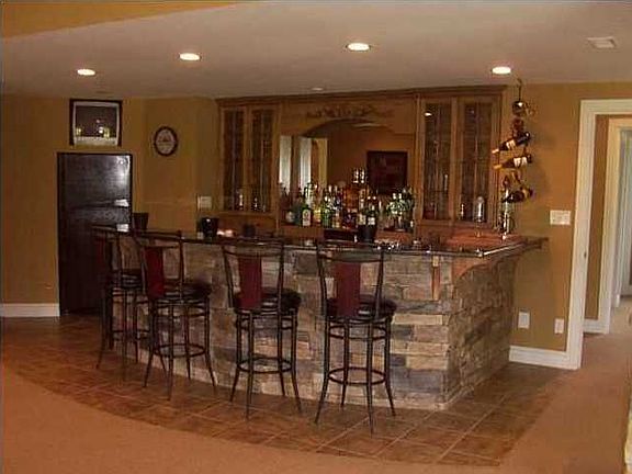 The WALK-OUT BASEMENT will indeed, make you say, "WOW!!!" The curved bar is a classy combination of stone & granite with a huge mirrored wall.