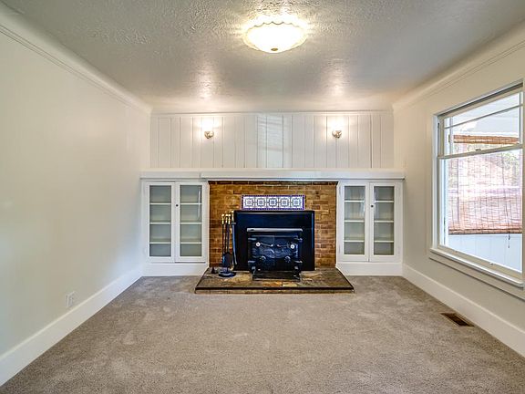 living room with wood burning fireplace