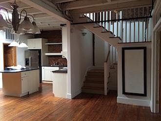 kitchen and stair to rooftop deck