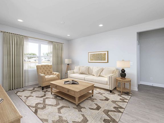 Open Gathering Room that flows into the Dining Room and Kitchen.