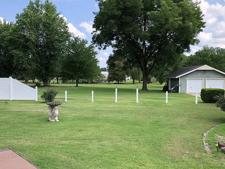 View of private backyard and additional acreage behind yard. Rear shop is on the property but not included in the lease