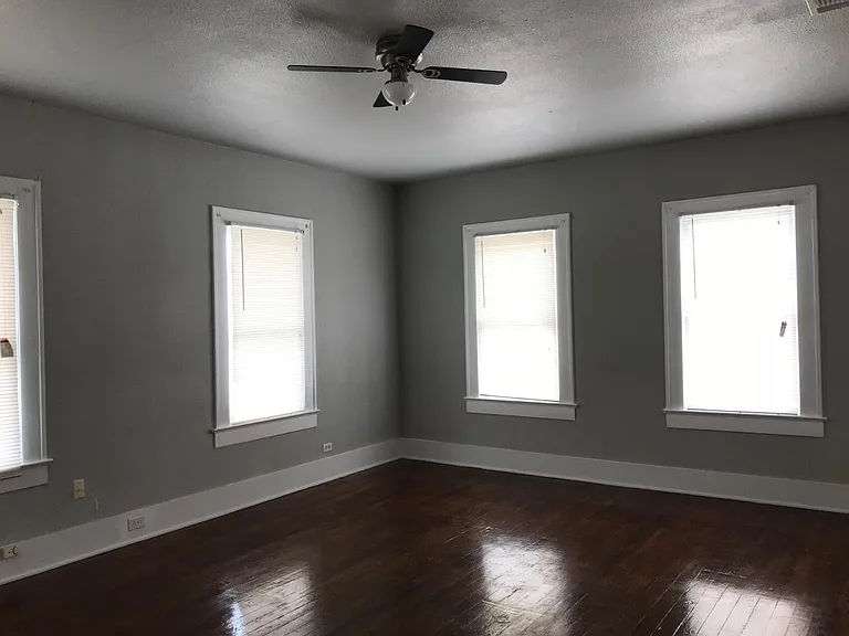 Huge master bedroom with walk-in closet and ceiling fan.