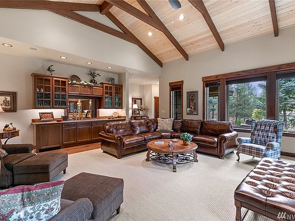 Great Room features Built-in Wet Bar, Including Granite Counter-Tops, Refrigerator and Sink.