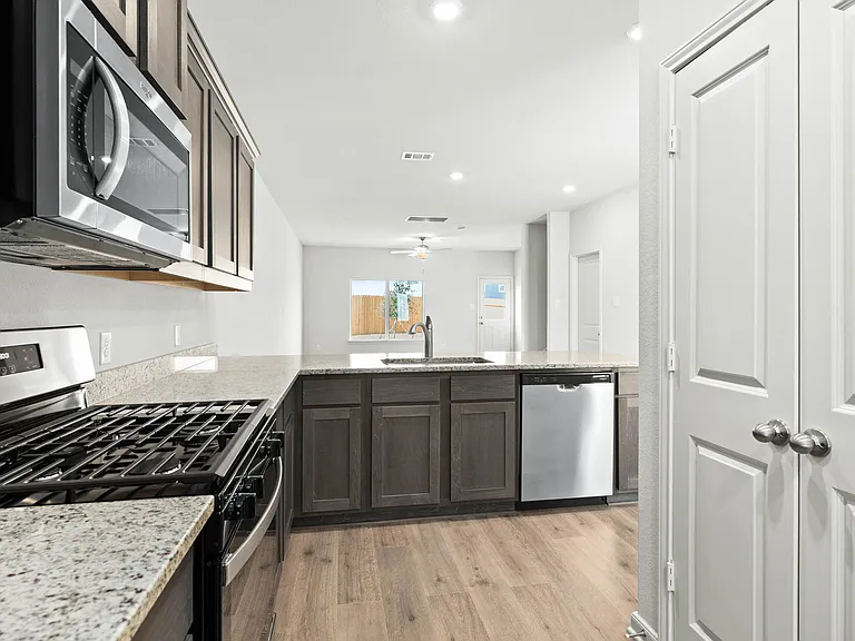 The kitchen looks out into the dining room.