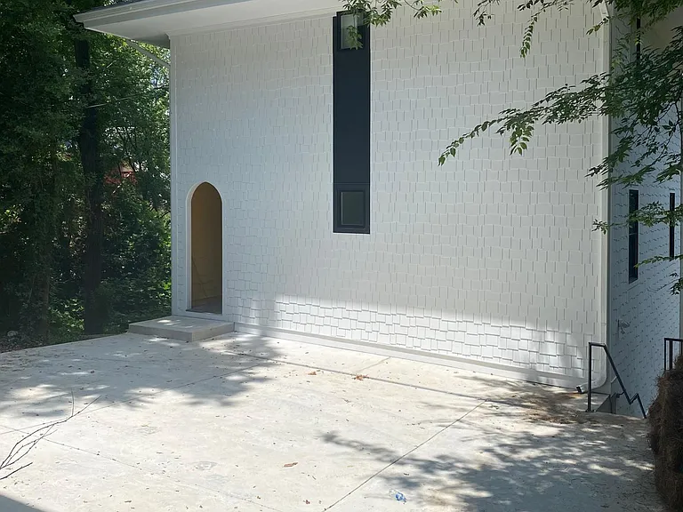 The Carriage House building in the back including one off-street parking space.