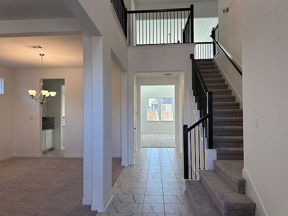 Construction progress - entryway with grand staircase and open to a formal living dining room