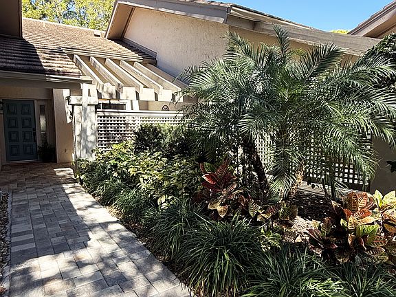 Lush tropical gardens surround the home.