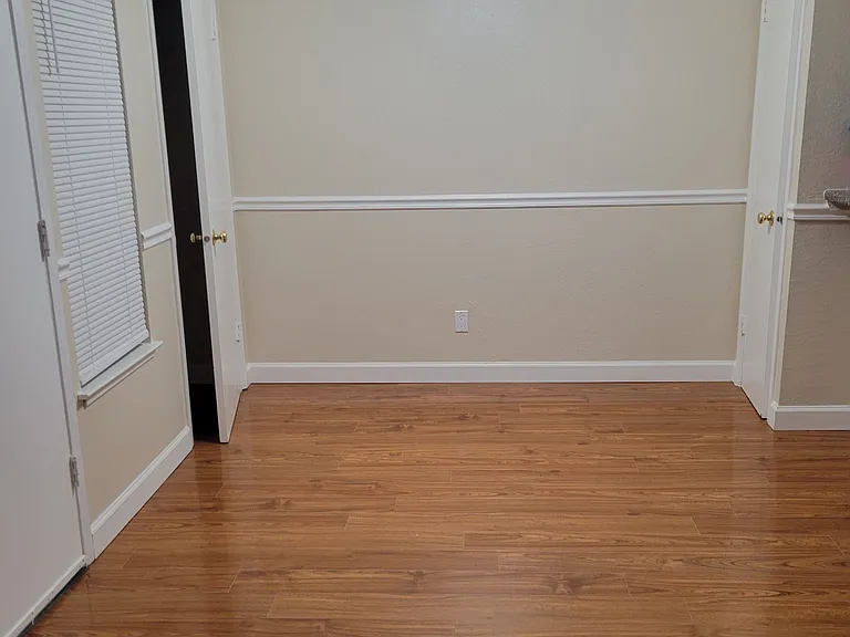 Dining room area with ceiling fan. Coat closet on left and pantry closet on the right