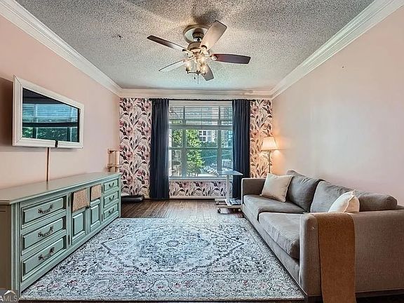 Bright, spacious living area with natural lighting and ceiling fan (in addition to central heat and air).