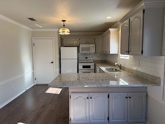 Updated kitchen with granite, refrigerator and pantry