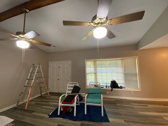 In den looking toward the front door (double doors!). Bay window that's the perfect place for a holiday tree!