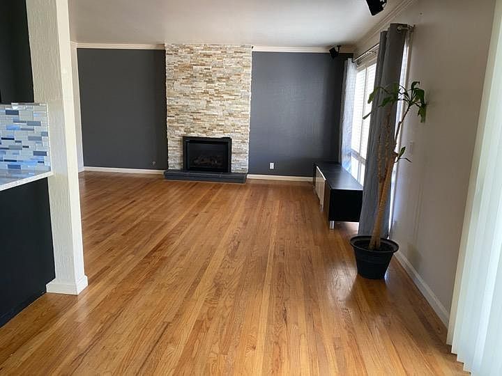 View from the dining area to the living room with upgraded gas fireplace! (Holds 6 person dining room table and buffet)
