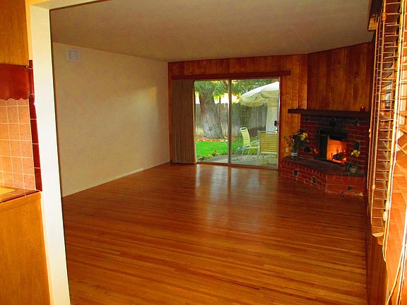 Spacious livingroom with gleaming, original real-hardwood floors. Gorgeous fireplace.
