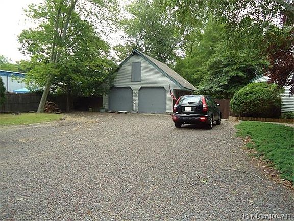 Large garage with a storage loft. Large driveway.