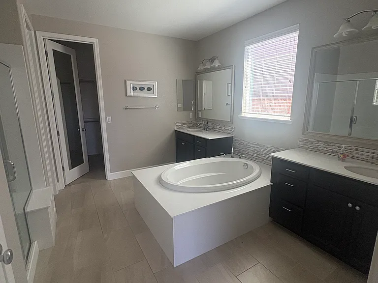Primary bathroom- 2 sinks, bathtub, and shower