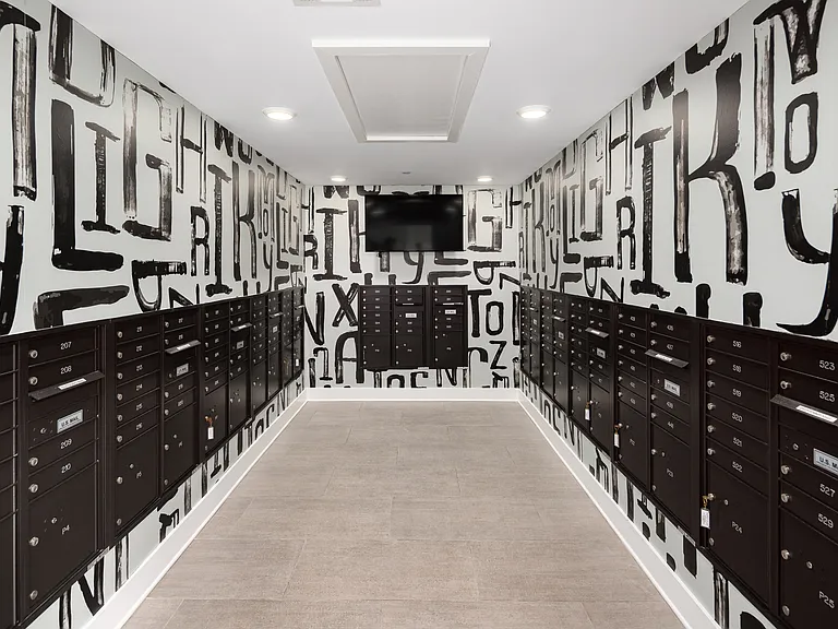 Modern Mailroom with Secure Black Mailboxes and Bold Typography Accent Wall