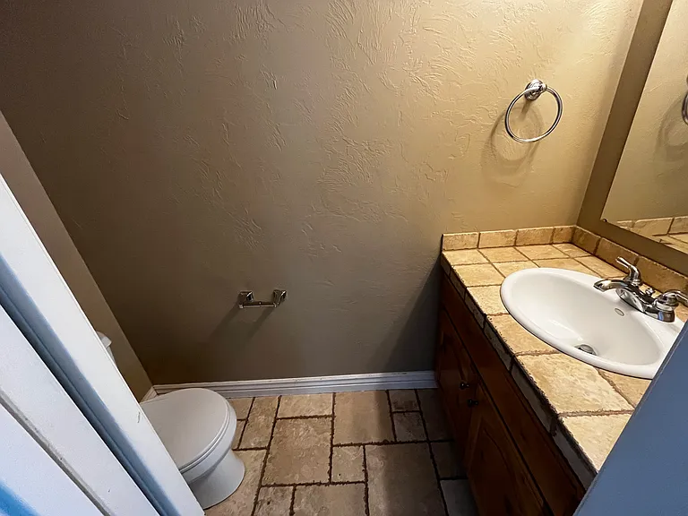 1/2 bath with pocket door access through kitchen.