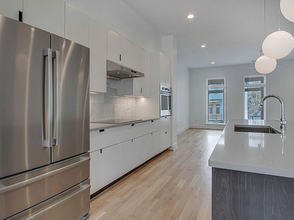 solid hardwood cabinets, Bosch applicances: induction cooktop, wall oven, 4-door fridge