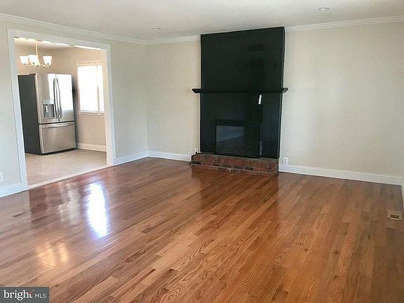 Living Room with Marble Electric Fireplace and Entrance to