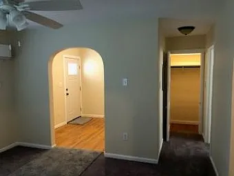Living/Bedroom area looking to entry, hall and closet area.