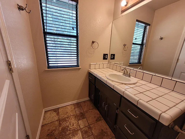 Master Bath has white granite and new sink