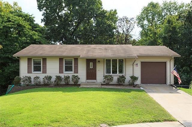 Vinyl Sided, newer doors, enclosed soffit & fascia, newer windows, newer garage door, beautiful landscaping and backs to woods!