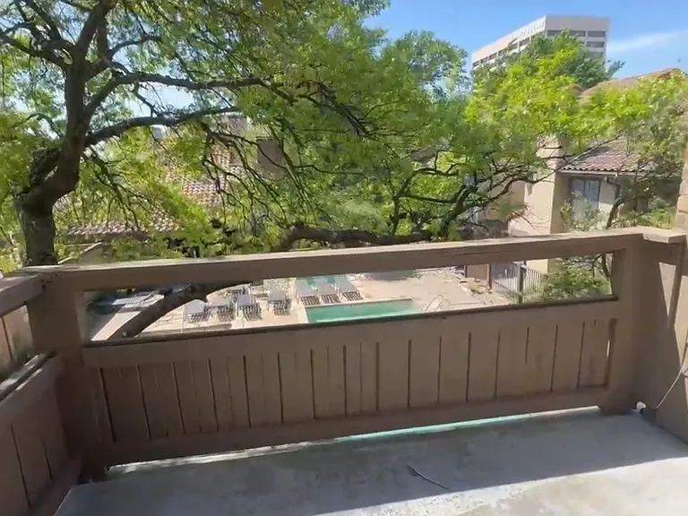 Balcony with a pool view. Additional enclosed storage on the patio.