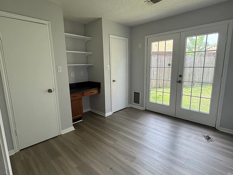 Bedroom #2 with work station, French doors and dual closets