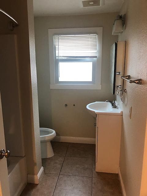 Bathroom w shower tub combination on the left.