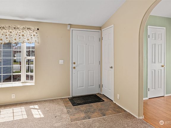 Tiled entry area with coat closet>