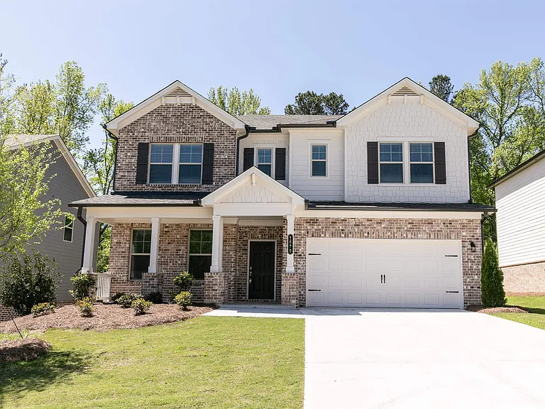 Exterior of the Prescott, two story home with a private driveway and attached garage.