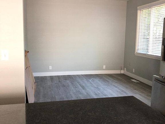 Living room, very large window with blinds and skylight