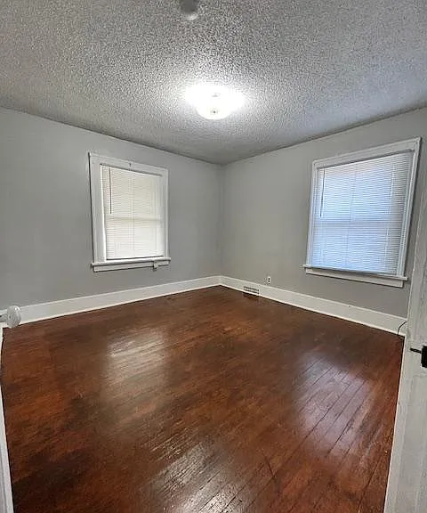 Bedroom #2. Larger of the two bedrooms. Bedroom is also on the west side of house that faces the street. Lots of natural light. Hardwood floors and closet.