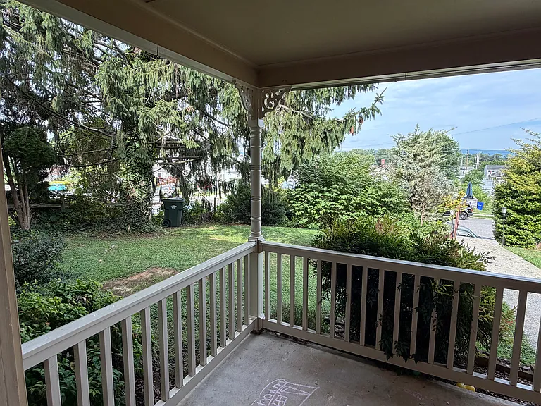 Enjoy the front porch. Property sits on hill offering a lovely view.