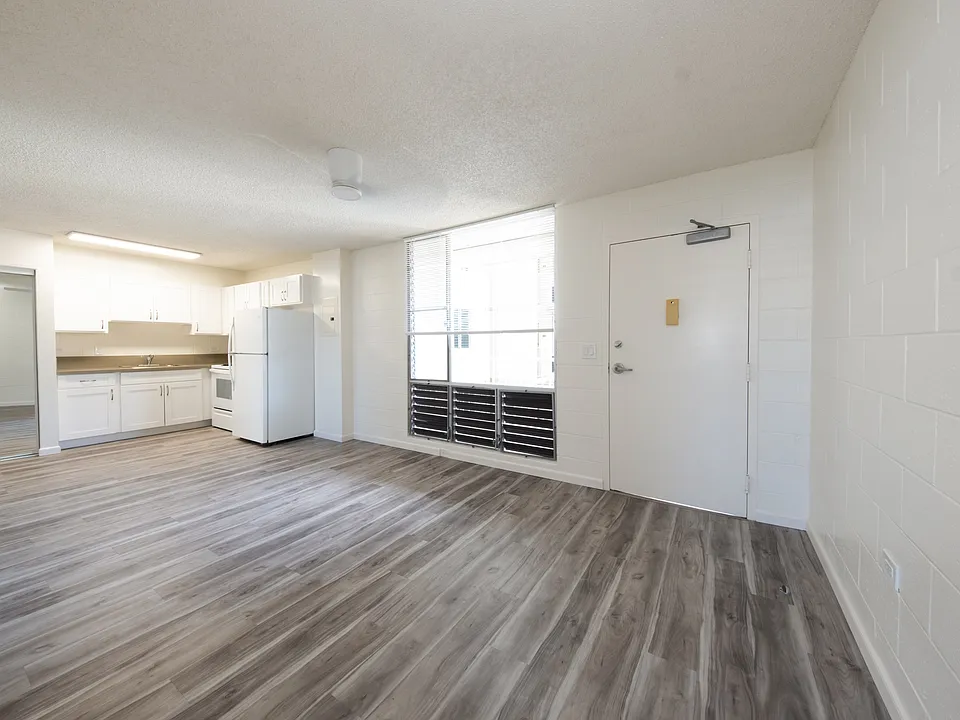 Open-concept living space featuring modern flooring and a bright ambiance.